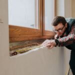 carpenter measuring window ledge in new house rakr