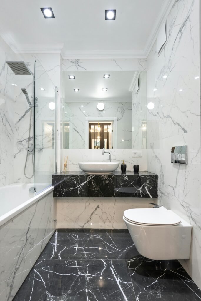 Luxurious bathroom featuring marble walls and floor with modern fixtures and minimalist design.